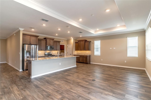 kitchen featuring appliances with stainless steel finishes, dark wood-style flooring, plenty of natural light, and visible vents