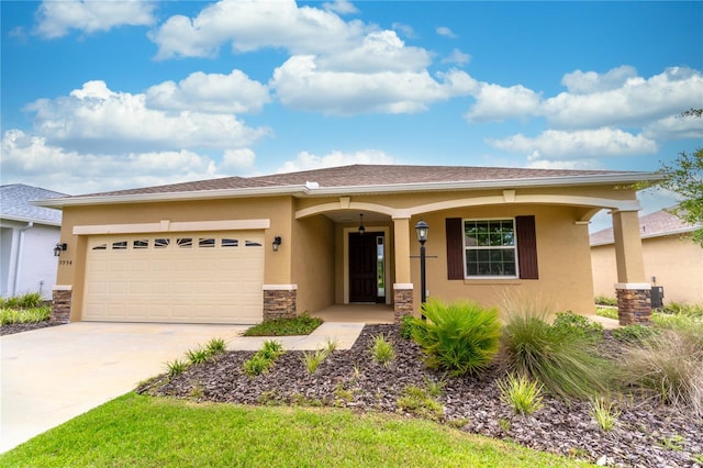 view of front facade with stucco siding, concrete driveway, an attached garage, central AC unit, and stone siding