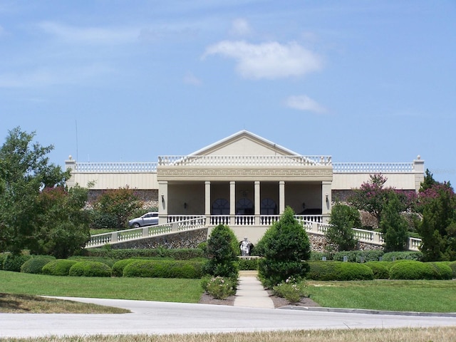 neoclassical / greek revival house with covered porch and stucco siding