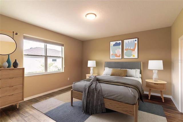 bedroom featuring wood finished floors and baseboards