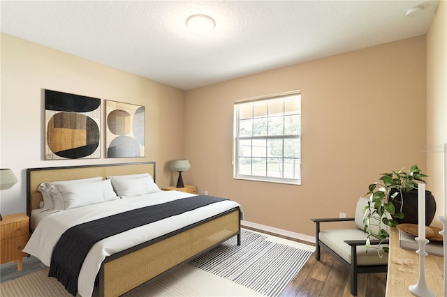 bedroom featuring baseboards and wood finished floors