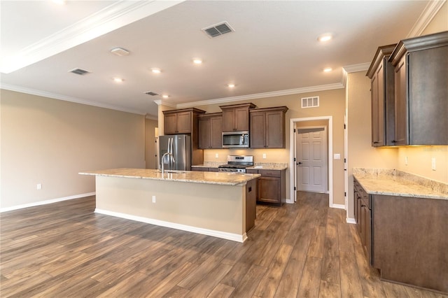 kitchen with a center island with sink, visible vents, stainless steel appliances, and dark wood-type flooring