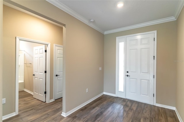 entrance foyer with dark wood-style floors, ornamental molding, and baseboards