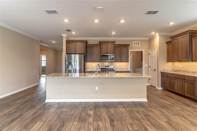 kitchen with a kitchen island with sink, stainless steel appliances, and visible vents