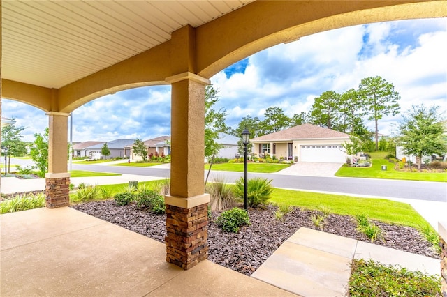 9994 SW 96th St, Ocala, FL 34481 - view of patio / terrace with an attached garage, covered porch, a residential view, and concrete driveway