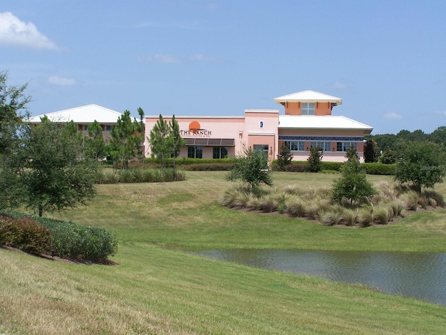 9994 SW 96th St, Ocala, FL 34481 - exterior space with a water view, stucco siding, and a front lawn