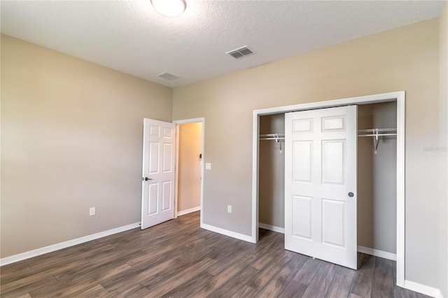 9994 SW 96th St, Ocala, FL 34481 - unfurnished bedroom featuring a textured ceiling, a closet, visible vents, wood finished floors, and baseboards