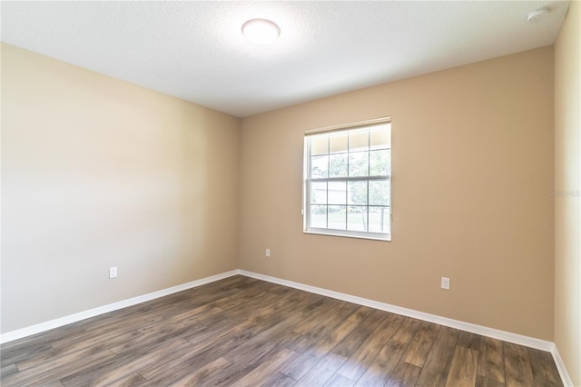 9994 SW 96th St, Ocala, FL 34481 - unfurnished room with baseboards, a textured ceiling, and dark wood finished floors