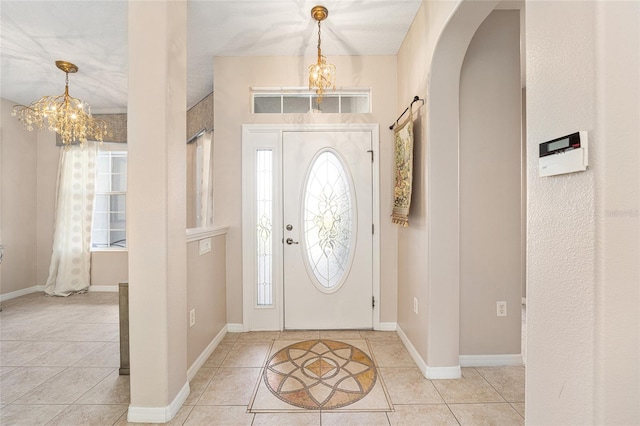 foyer featuring an inviting chandelier and light tile patterned floors