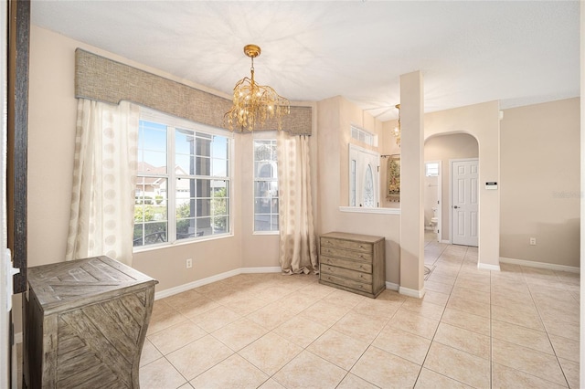 tiled dining room with a notable chandelier