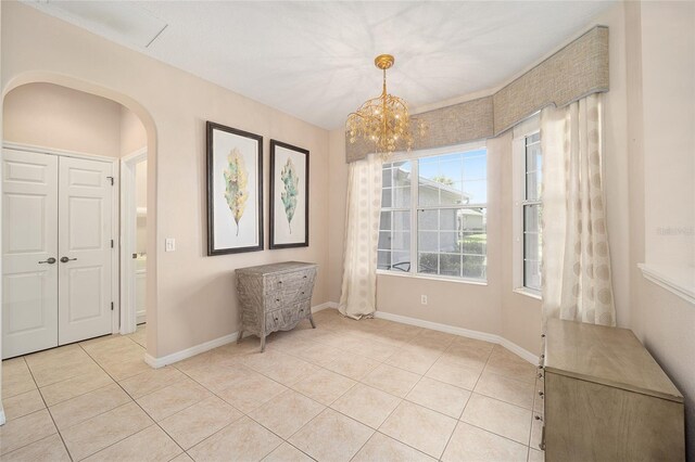 unfurnished dining area featuring a notable chandelier and light tile patterned floors