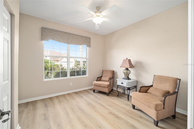 sitting room featuring ceiling fan and light hardwood / wood-style floors