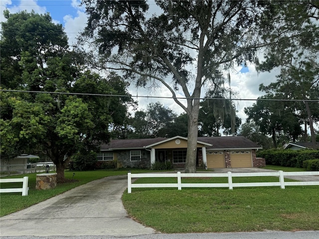 ranch-style house featuring a front yard and a garage