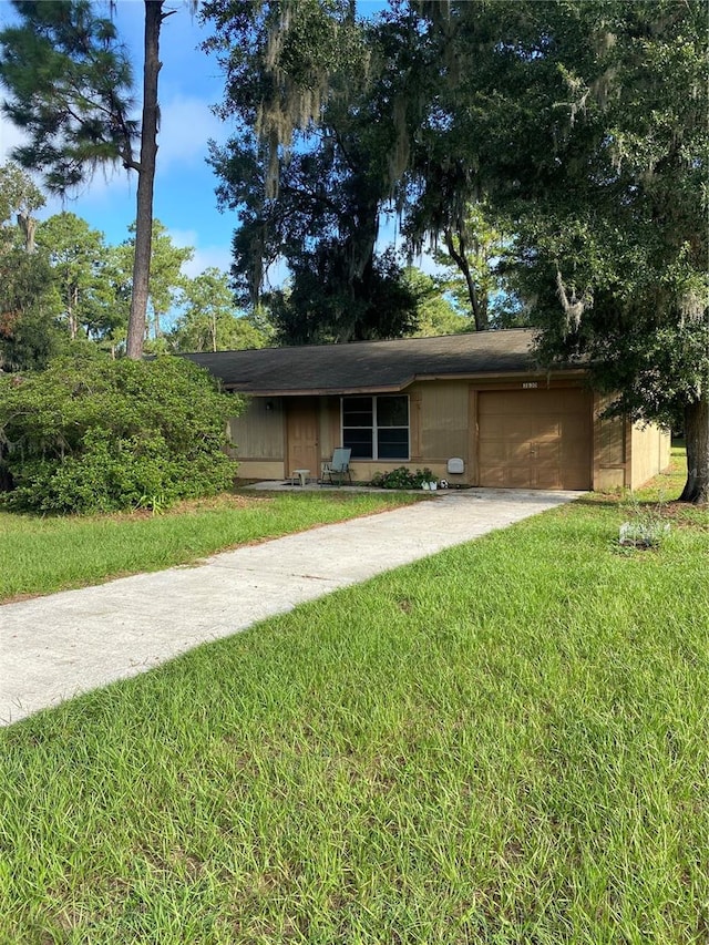 view of front facade with a garage and a front yard