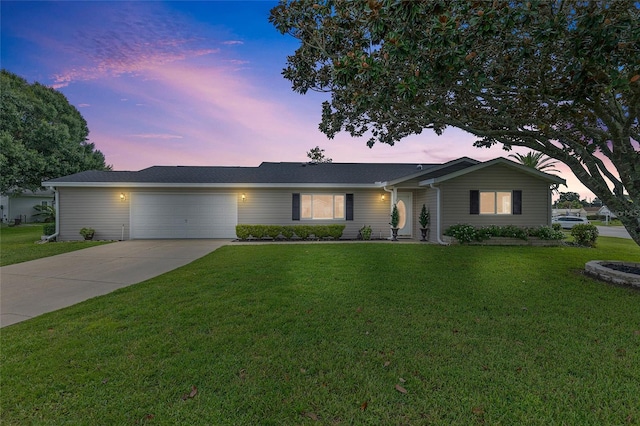 ranch-style home with a yard and a garage