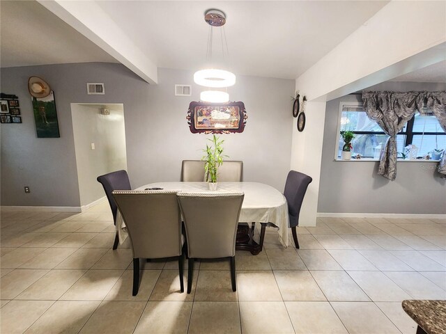 tiled dining room with vaulted ceiling