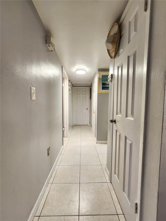 hall with light tile patterned floors