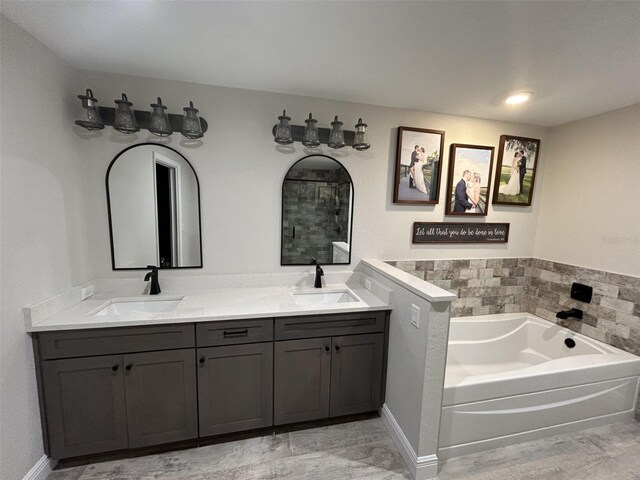 bathroom featuring vanity and a tub