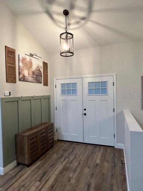 entryway with lofted ceiling and dark wood-type flooring