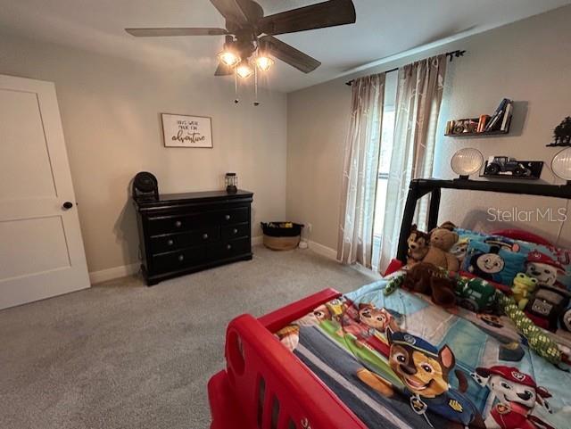 carpeted bedroom with ceiling fan