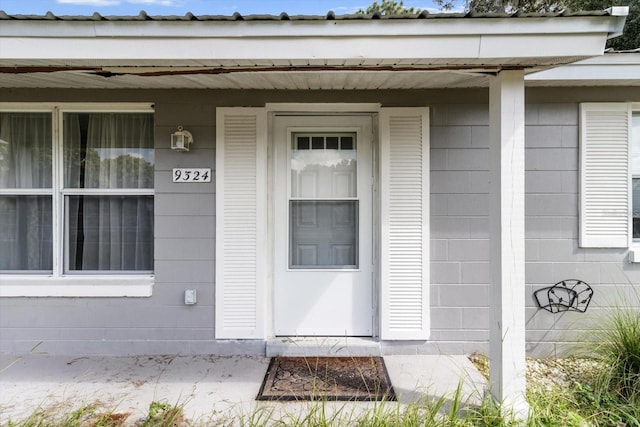 view of exterior entry with covered porch