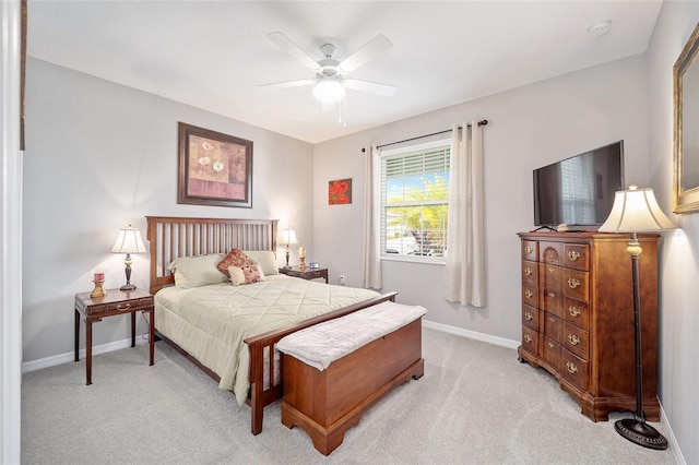 bedroom with light carpet, ceiling fan, and baseboards