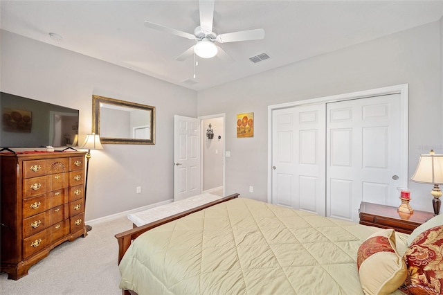 carpeted bedroom featuring baseboards, ceiling fan, visible vents, and a closet