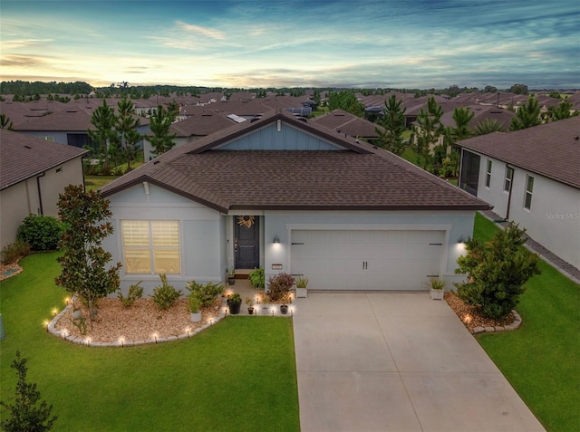 single story home with a yard and a garage