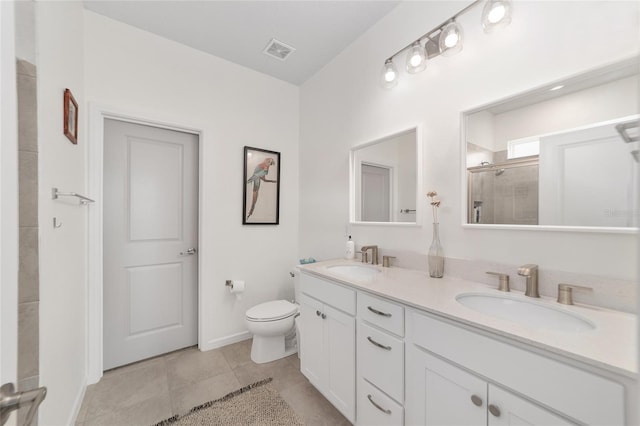 bathroom with vanity, tile patterned flooring, a shower with shower door, and toilet