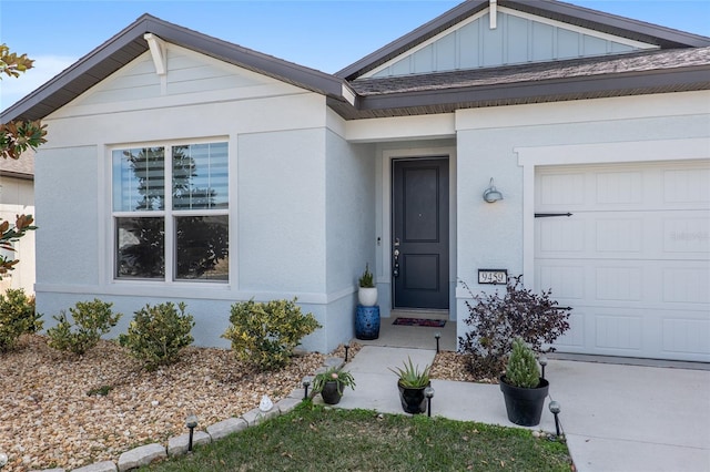 view of exterior entry with a garage