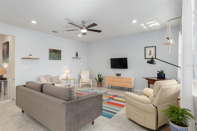 living room featuring light tile patterned floors and ceiling fan