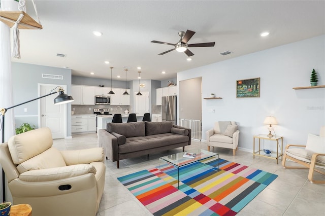 tiled living room with ceiling fan