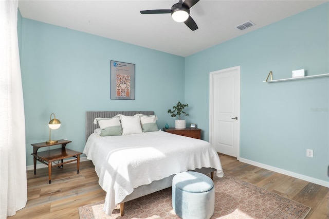 bedroom with light hardwood / wood-style floors and ceiling fan