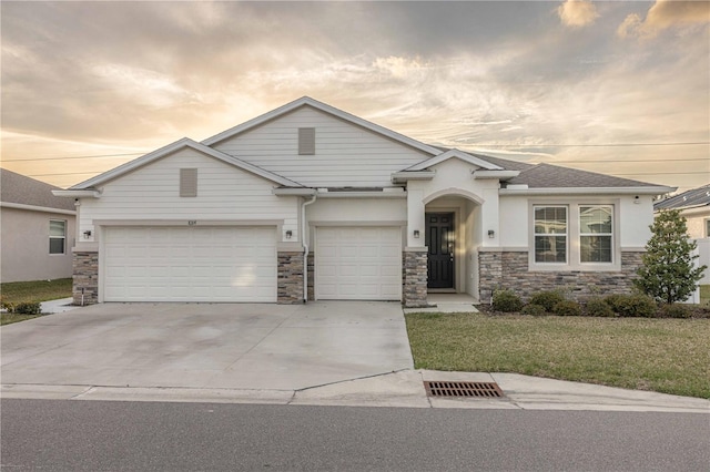 view of front of home featuring a garage and a lawn