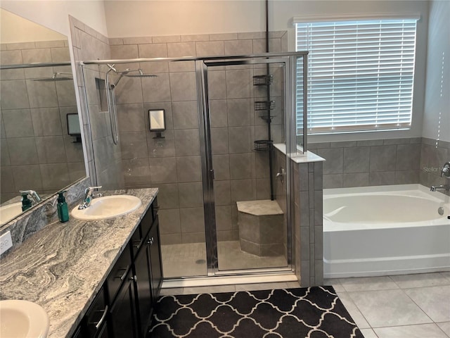 bathroom with tile patterned flooring, vanity, and separate shower and tub