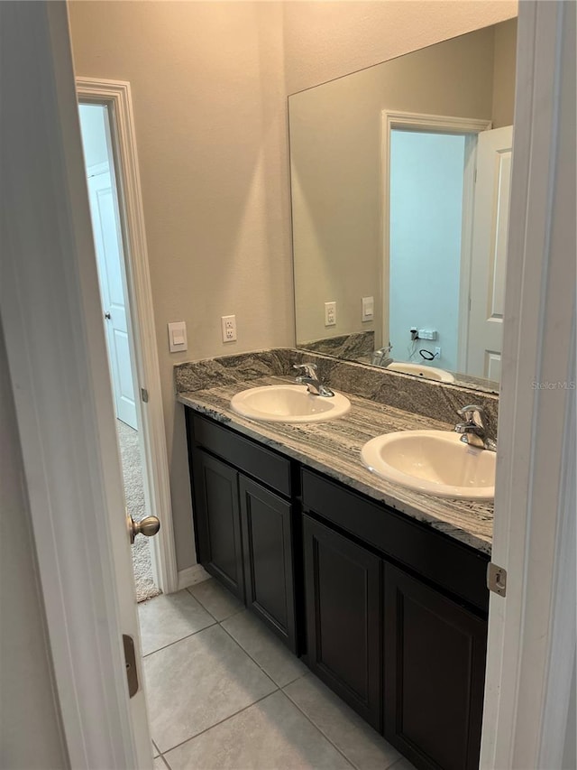 bathroom featuring tile patterned flooring, vanity, and toilet