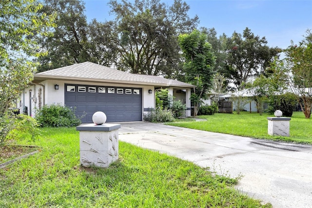 ranch-style home featuring roof with shingles, stucco siding, concrete driveway, an attached garage, and a front yard