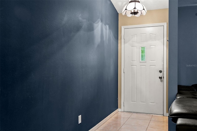 foyer entrance featuring light tile patterned floors and baseboards