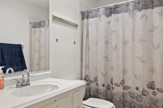 bathroom featuring toilet and vanity