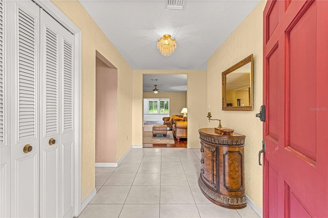 interior space featuring a textured ceiling and light tile patterned flooring