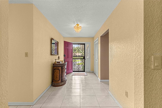 interior space featuring a textured ceiling and light tile patterned floors