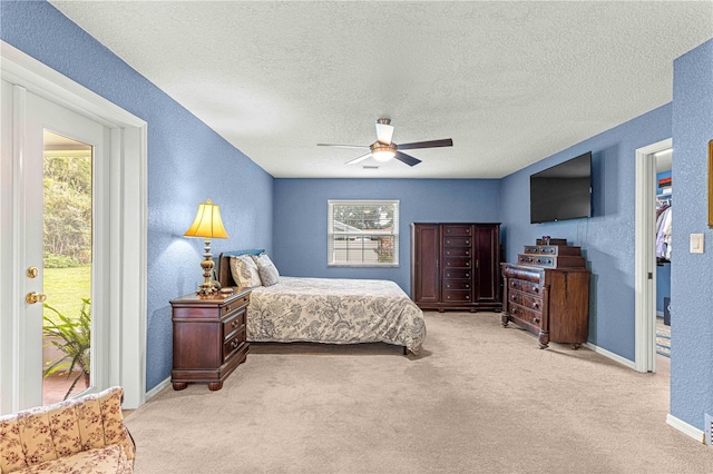 bedroom with a textured ceiling, light colored carpet, ceiling fan, and access to exterior