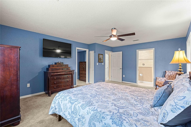 carpeted bedroom with a textured ceiling, ceiling fan, and connected bathroom