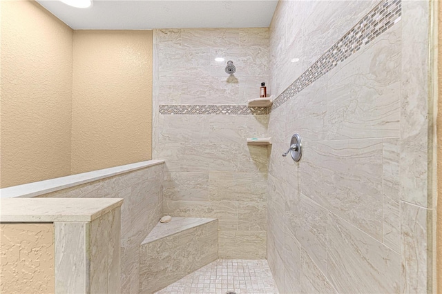 bathroom featuring tile walls and tiled shower