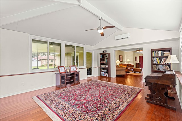 living area with ceiling fan, hardwood / wood-style floors, a wall mounted air conditioner, and lofted ceiling with beams