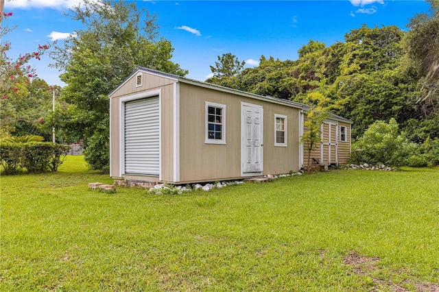 view of outbuilding featuring a lawn