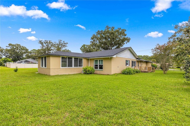 back of house with a yard and a wooden deck