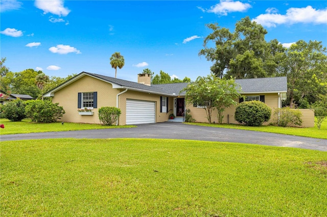 single story home with a front yard and a garage