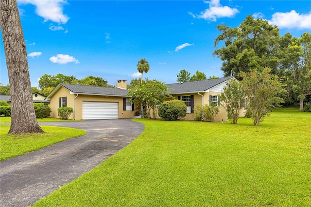 single story home with a garage and a front lawn