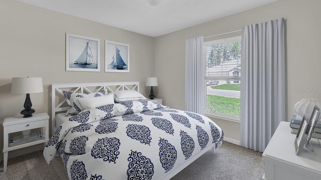 carpeted bedroom featuring a textured ceiling